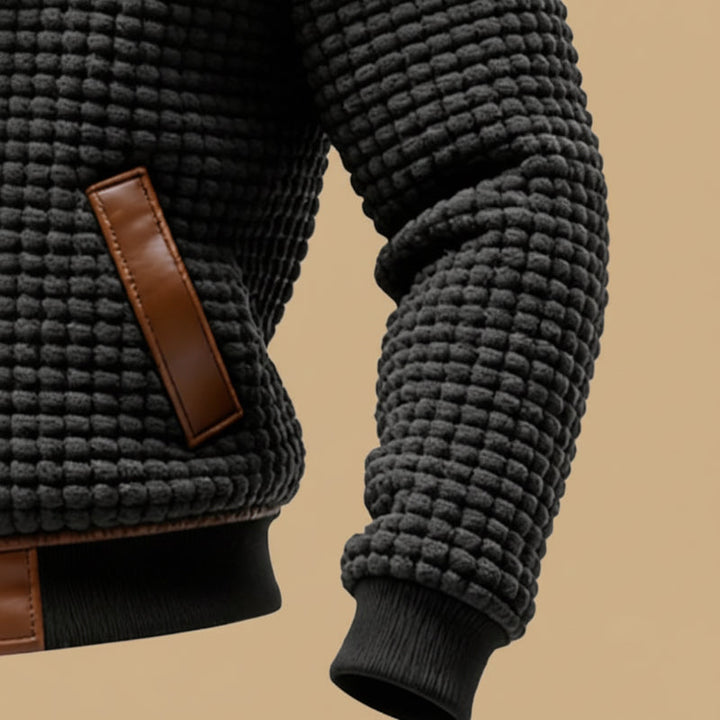 Close-up of a robust textured men's jacket, highlighting its cozy fabric and warm design for winter.