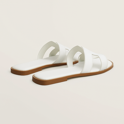 "Sandali piatti in pelle marrone donna con listini intagliati e regolabili, design elegante e traspirante estivo."
