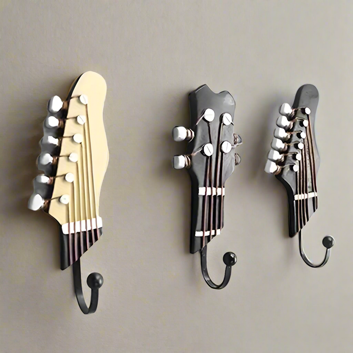 Set of 3 decorative guitar wall hooks for home organization & unique musical decor.