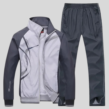 "Set sportivo uomo elegante, tessuto blu scuro, giacca con zip e pantaloni, design moderno, comfort elevato, vestibilità otti
