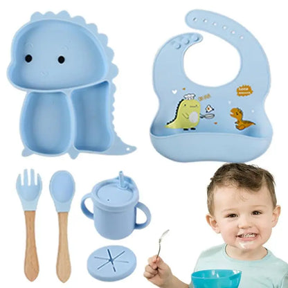 Set stoviglie silicone bambini, design dinosauro blu, antiscivolo, include piatto a ventosa, posate, bavaglino e bicchiere.