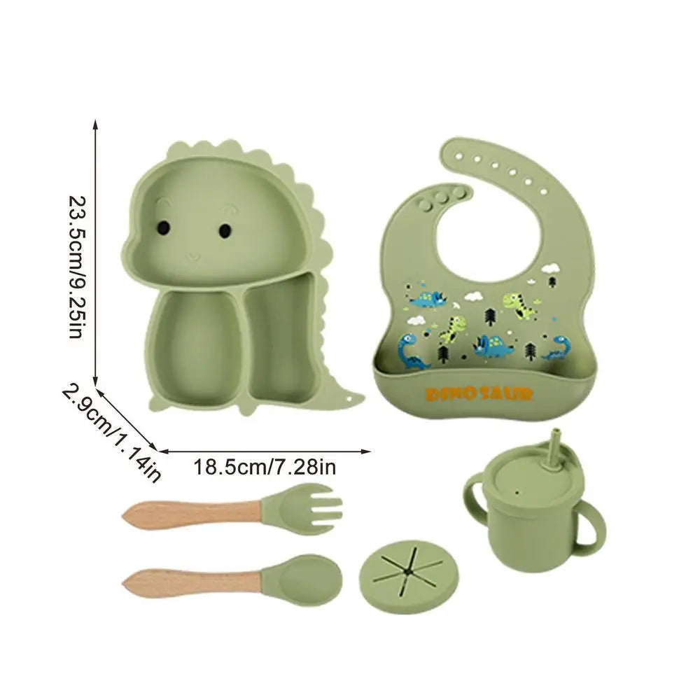 Set stoviglie silicone bambini, design dinosauro blu, antiscivolo, include piatto a ventosa, posate, bavaglino e bicchiere.