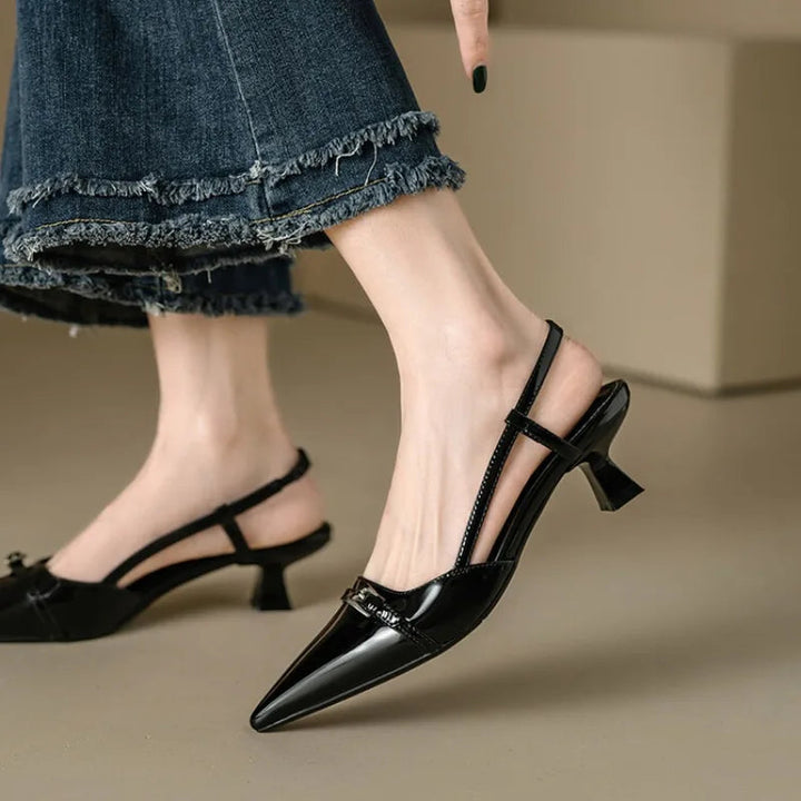 Versatile black pointed toe kitten heels for women, suitable for formal or evening wear.