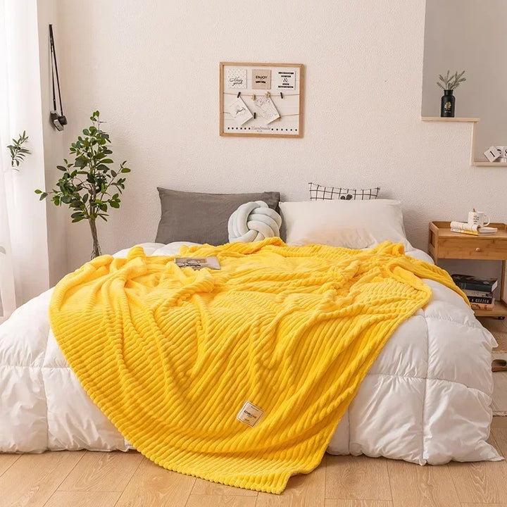 Warm flannel bed throw blanket, a plush and soft bedroom textile for ultimate winter comfort and decor.