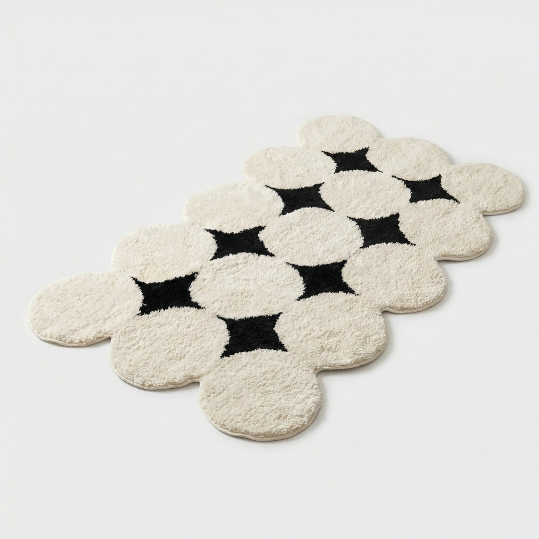 Textured Flowique non-slip bath mat featuring a plush cloud silhouette. Absorbent & soft for stylish bathroom decor.