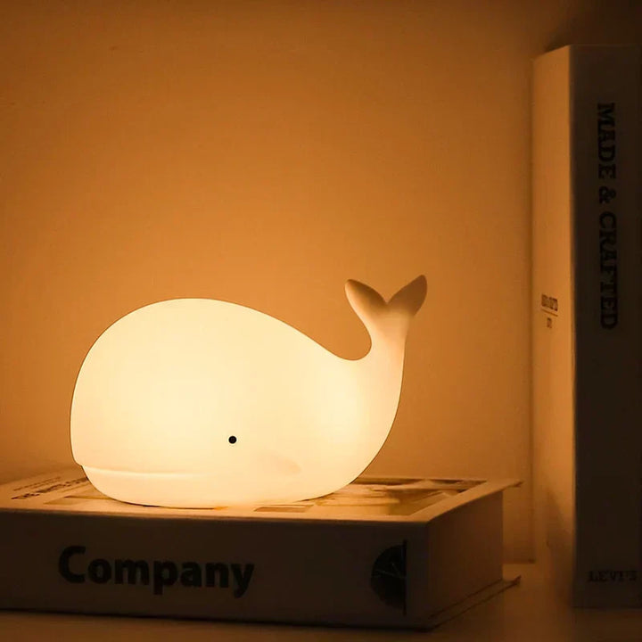 Soft silicone whale night light for kids, featuring color-changing LED & touch sensor for easy bedtime use.