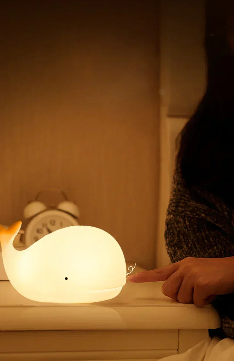 Child-safe silicone whale night light, a gentle sleep aid with soothing color-changing LED for bedtime.