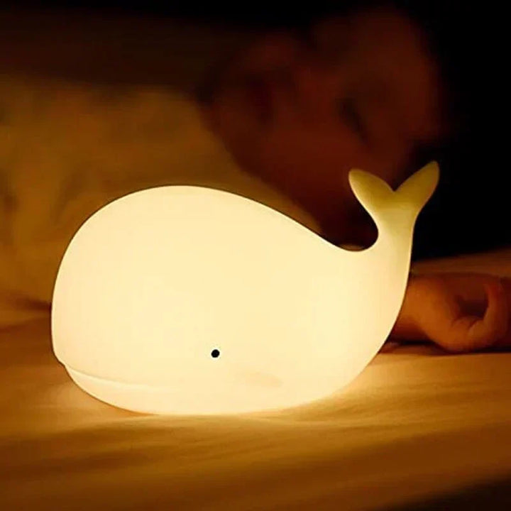 Playful whale design LED night light for children, offering color-changing ambiance & intuitive touch sensor.