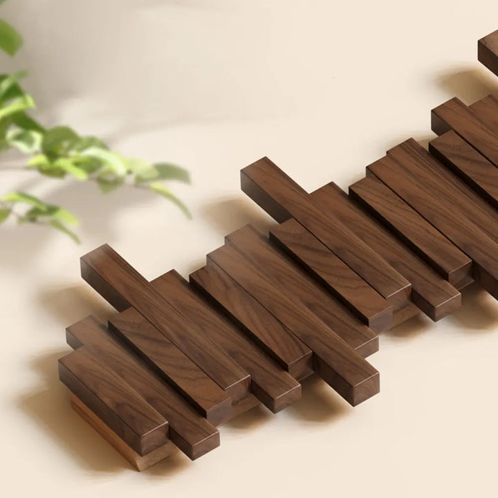 Modern natural wood wall hanger with retractable utility hooks. Perfect space-saving entryway organizer.