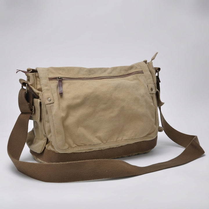 Rugged vintage canvas messenger bag with leather accents, perfect for a timeless unisex look.
