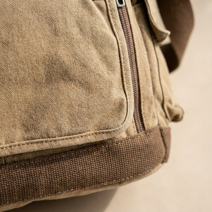 Durable canvas messenger bag, spacious design fits laptops & daily essentials. Ideal for work or school.