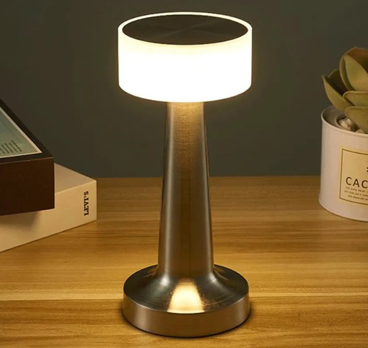 Sleek, portable LED table lamp. Wireless, rechargeable, and dimmable for versatile ambient lighting & decor.