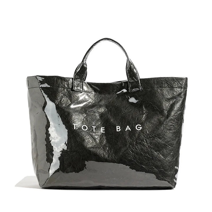 Everyday women's carryall tote bag featuring a fashionable high-gloss finish. Durable and stylish for daily use.