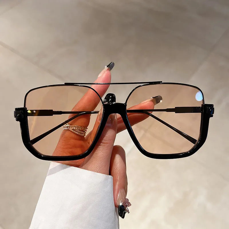 Stylish women's oversized square sunglasses with UV400 protection. Chic fashion accessory for eye protection.