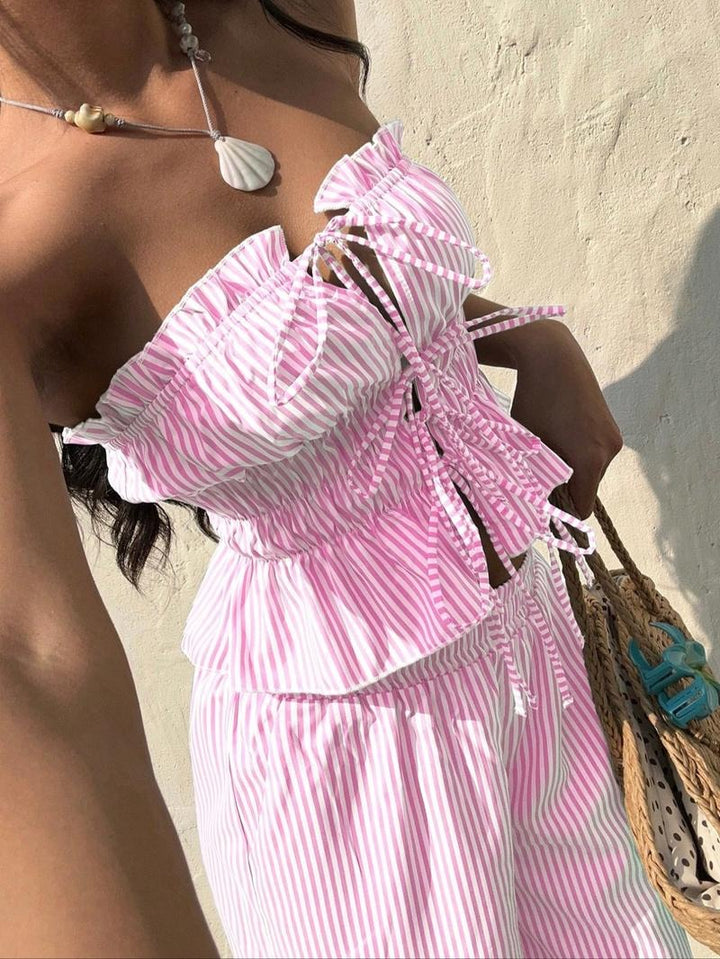 Full-length view of a women's pinstripe bandeau top and wide-leg pants set, showcasing summer style.