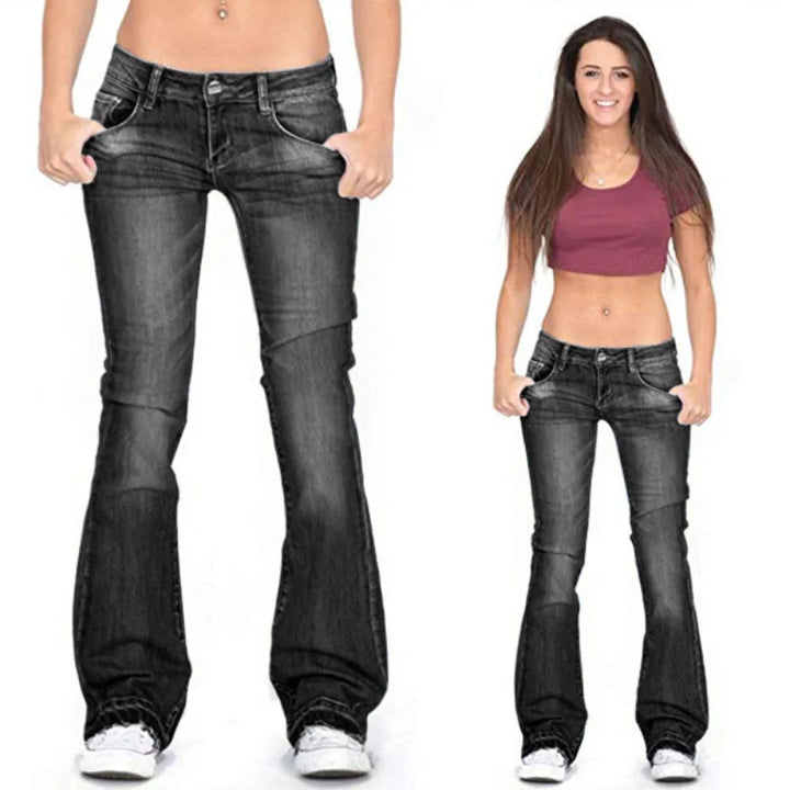 Woman modeling full-length vintage low-rise flared jeans, showcasing their chic retro flair & fit.