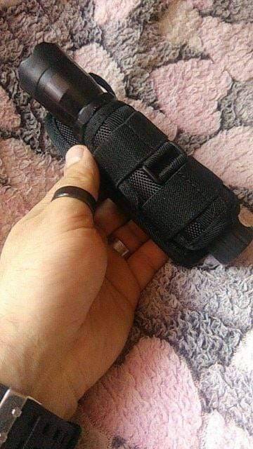 Tactical gear flashlight holster with 360-degree rotation for quick access