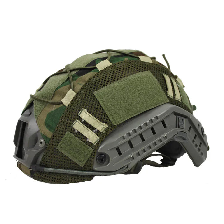 Tactical helmet cover with loop panels for patches, fitting FAST helmets, used in airsoft and tactical scenarios