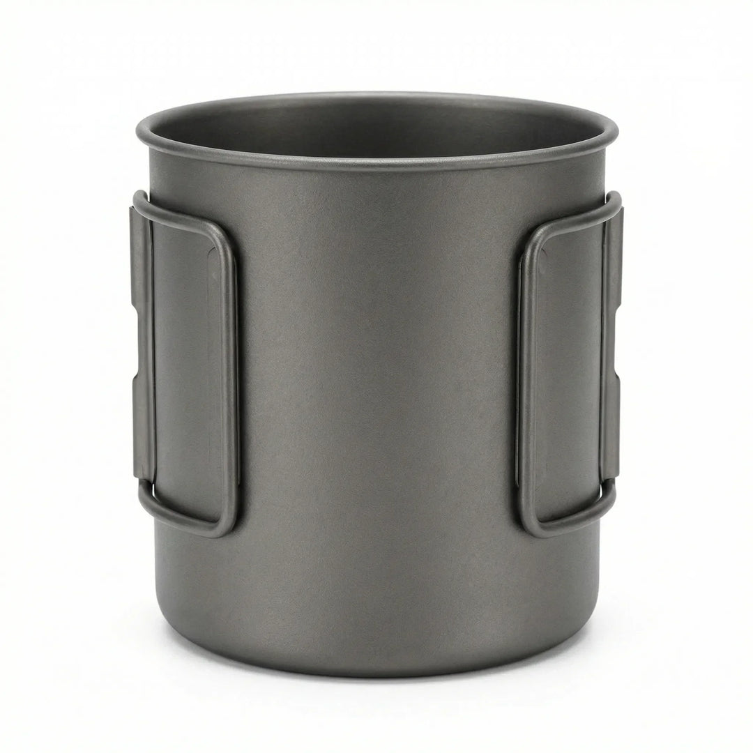 Durable titanium camping mug for outdoor cooking. Features a foldable handle for easy packing.