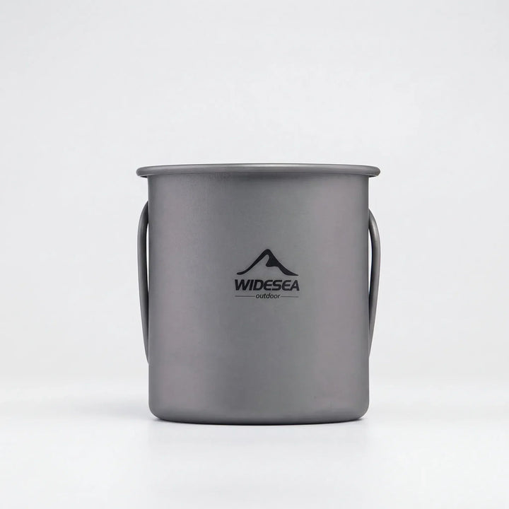 Portable travel mug made of titanium, featuring a foldable handle; ideal for hiking and camping.