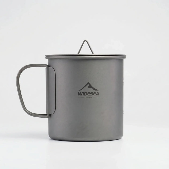 Compact titanium camping mug with foldable handle, essential outdoor cooking and travel gear.