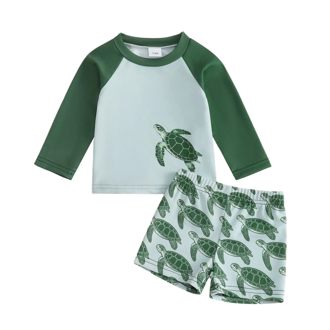 Playful tortoise print long-sleeve rash guard and swim bottoms for toddler girls' beachwear fun.
