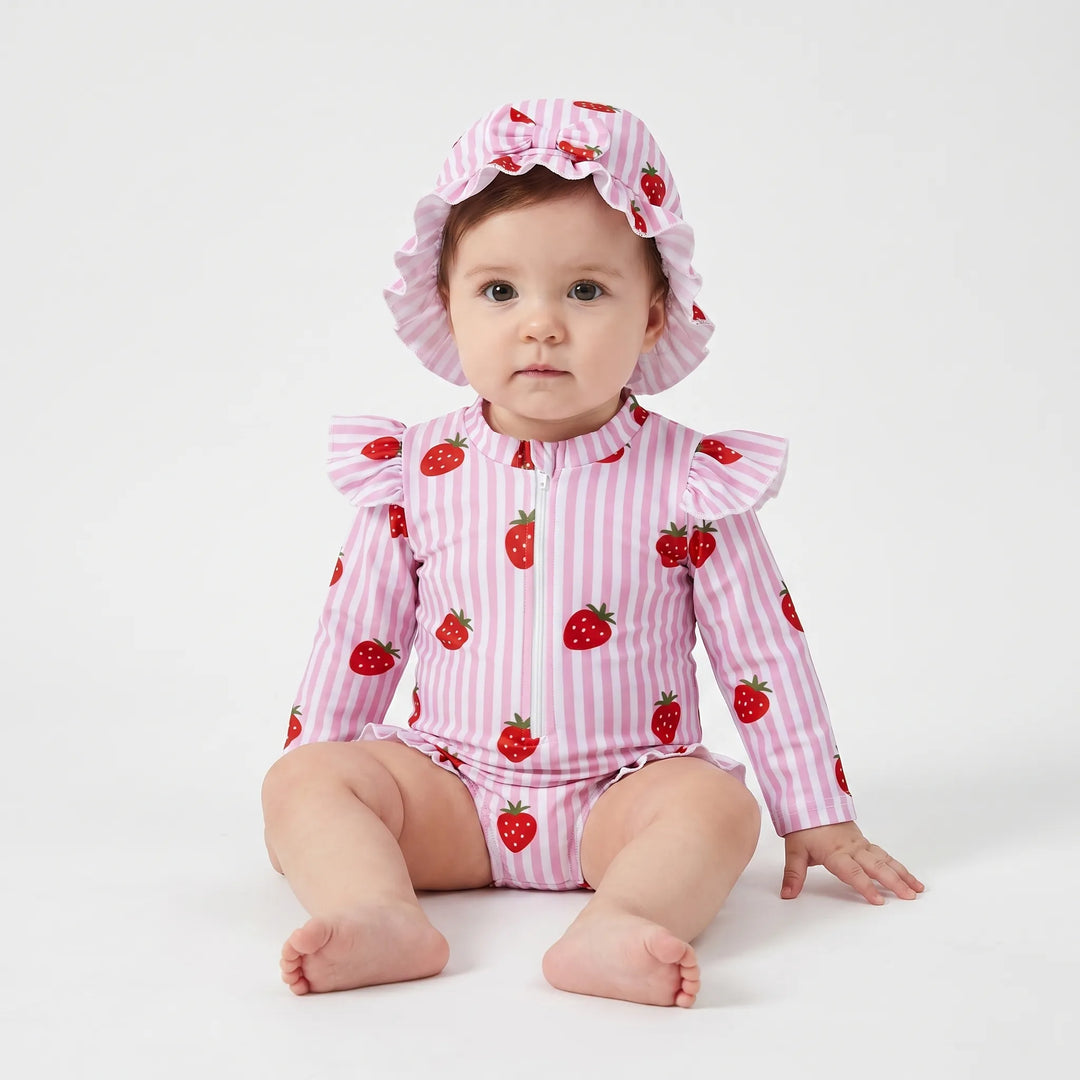 Frilly toddler girls' long-sleeve rashguard swimsuit & swim hat. Stylish sun protection for summer fun.