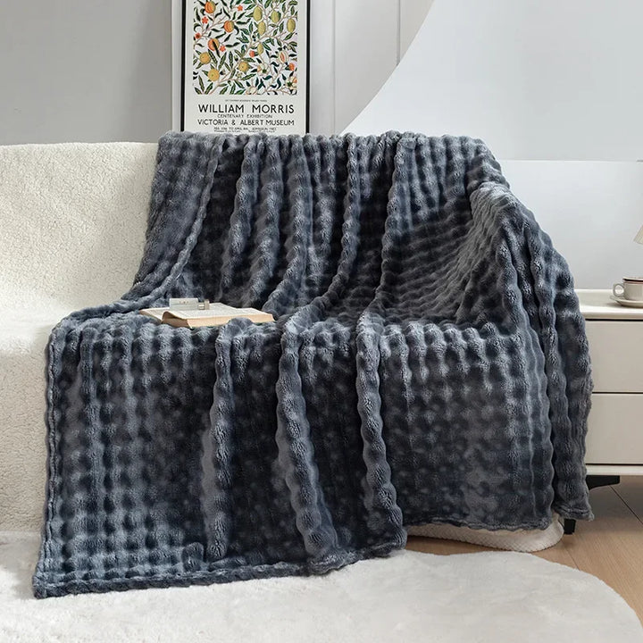 Close-up of the ultra soft bubble flannel texture on a comfortable throw blanket, enhancing home decor.