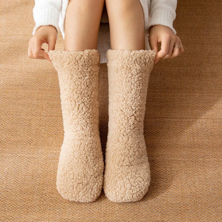 Pair of ultra-soft women's mid-calf cozy winter socks, providing warmth, comfort, and a non-slip sole.