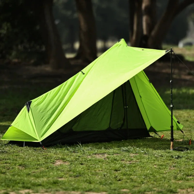 Portable camping shelter: a 1-person trekking pole tent packed for hiking