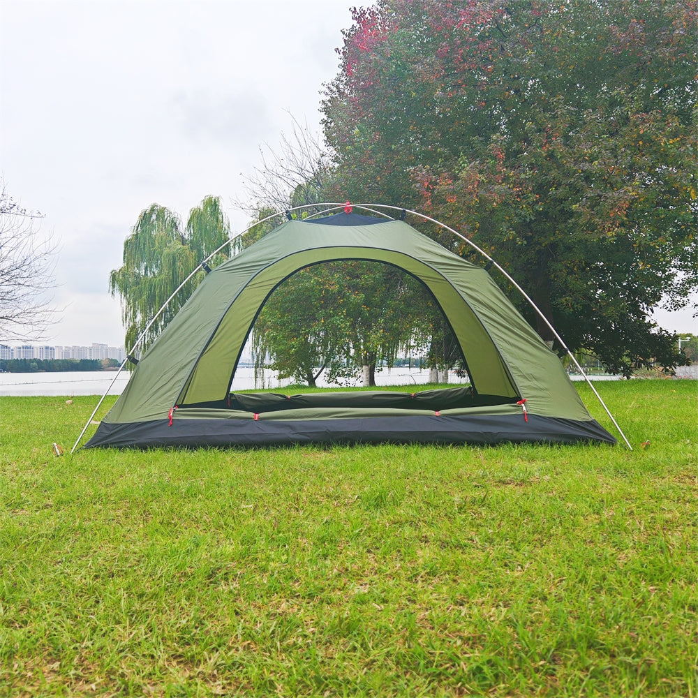 Army green ultralight 2-person tent packed in its carry bag, showing compact size for travel and backpacking.