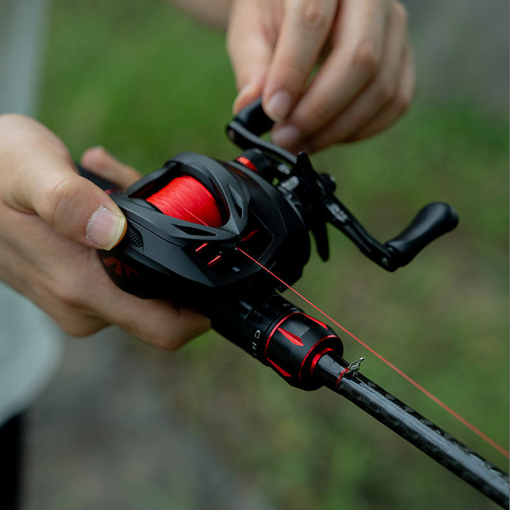 Hands-on view of an ultralight baitcasting reel, demonstrating its ergonomic fit and functional design for long fishing trips