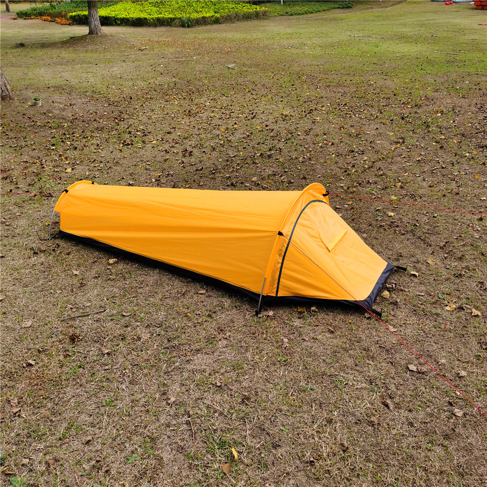 Bivy tent door open, revealing the easy entry and exit for a backpacker.