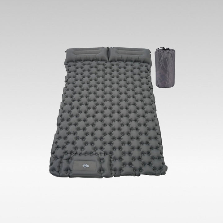 Ultralight inflatable camping mattress with built-in foot pump, shown deflated for portability.