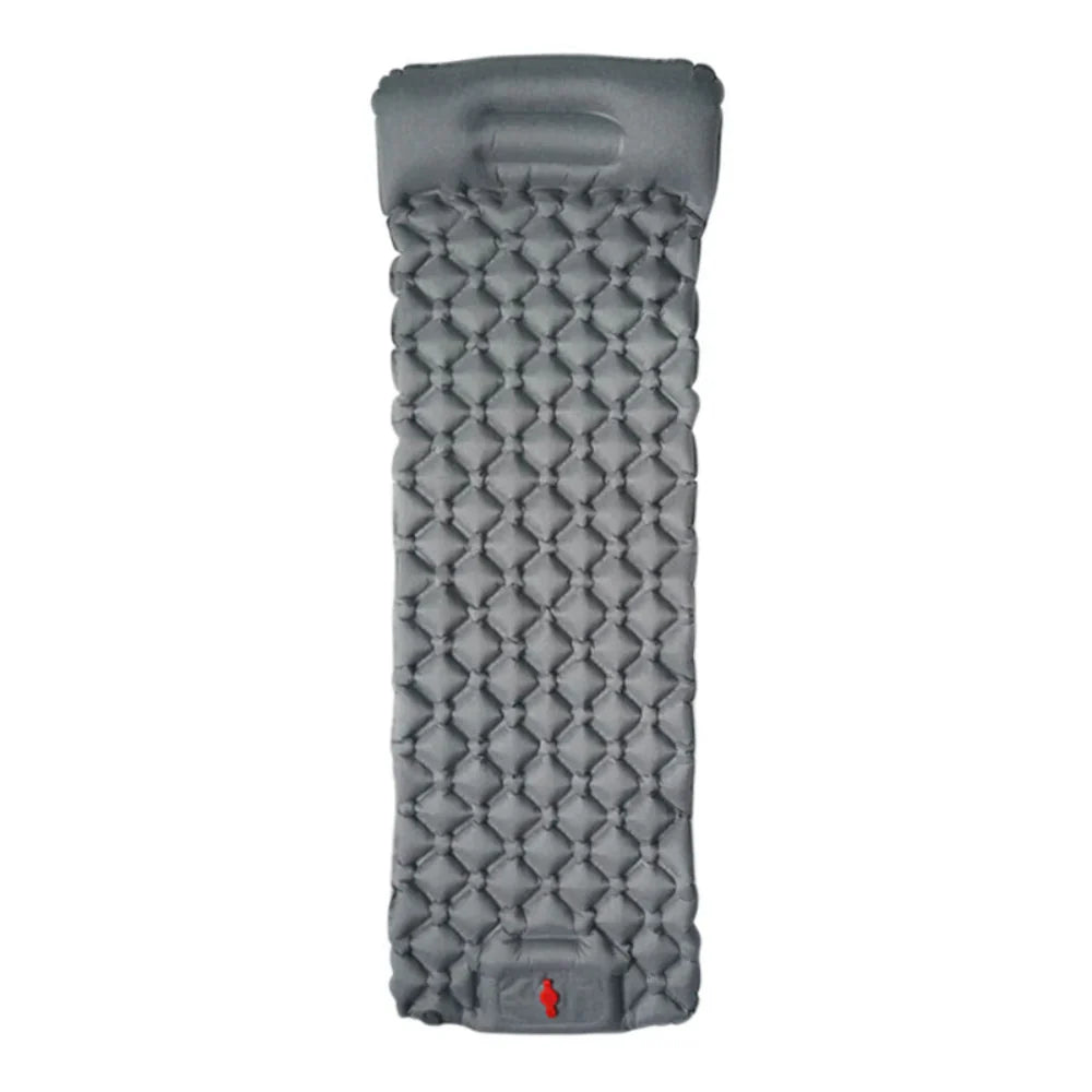 A person easily carrying a packed ultralight camping mattress, emphasizing portability.