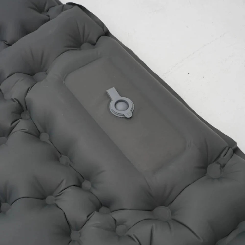 Foot actively pumping an ultralight inflatable mattress, quick inflation process.
