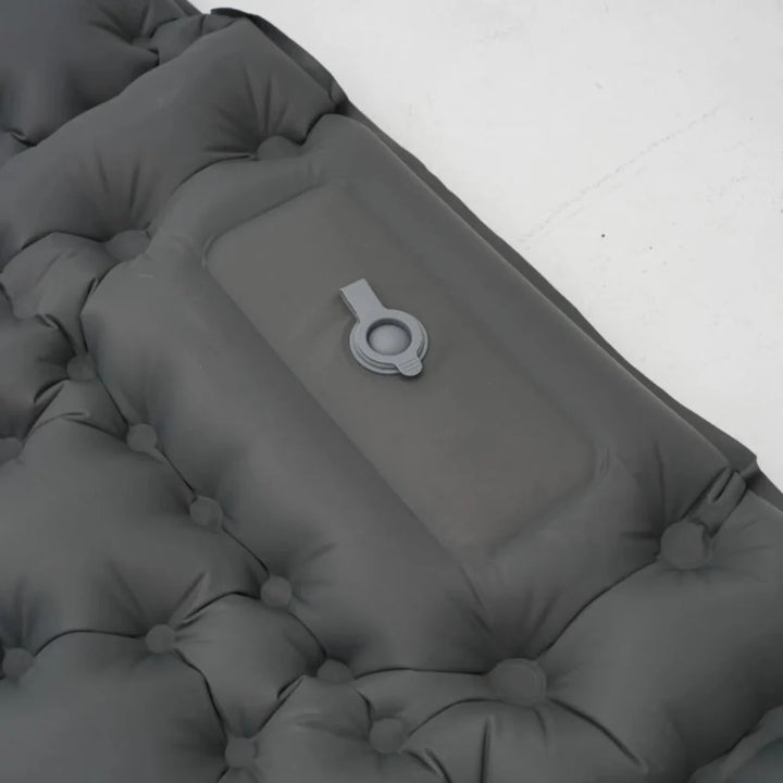 Foot actively pumping an ultralight inflatable mattress, quick inflation process.