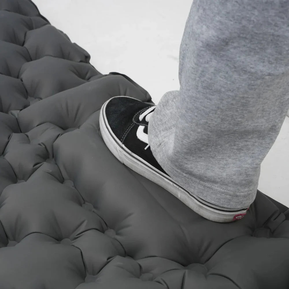 Ultralight camping mattress with a person resting comfortably, illustrating its support.
