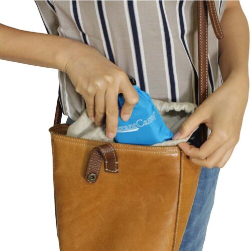 Hiking pillow, blue, inflatable, illustrating its small packed size next to a water bottle