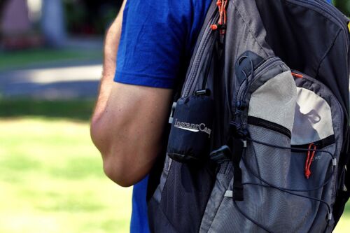 Hiking camping pillow, light blue, inflated, demonstrating its ergonomic shape