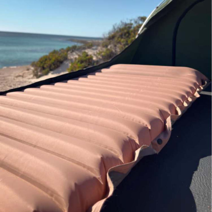 Camping gear: view of an inflatable mattress with integrated foot pump, perfect for backpacking.