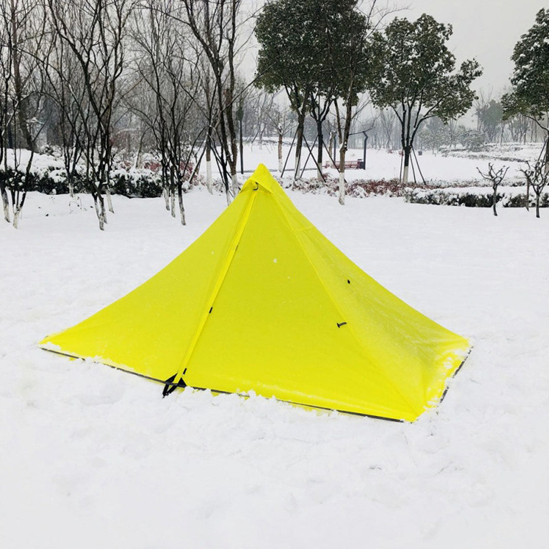 Interior shot of the pyramid tent at night, with a headlamp, showing cozy sleeping area.