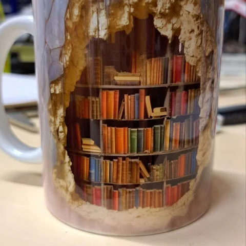 Unisex ceramic 3D Bookshelf Mug, a unique literary gift. Perfect for bookworms enjoying tea or coffee at home/office.
