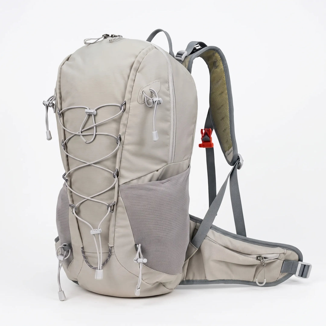 Unisex 6.6 gallon lightweight hiking daypack shown on a hiker on a scenic outdoor trail.