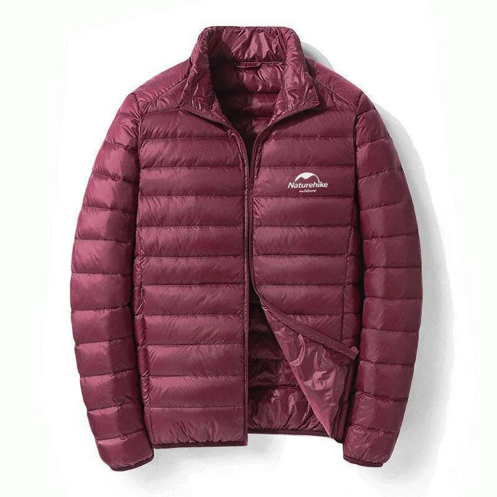 Side view of model in lightweight 800FP duck down jacket, showcasing sleek outdoor gear design.