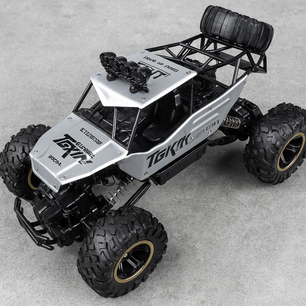 Unisex All-Terrain RC Monster Truck tackling rough terrain with big wheels.