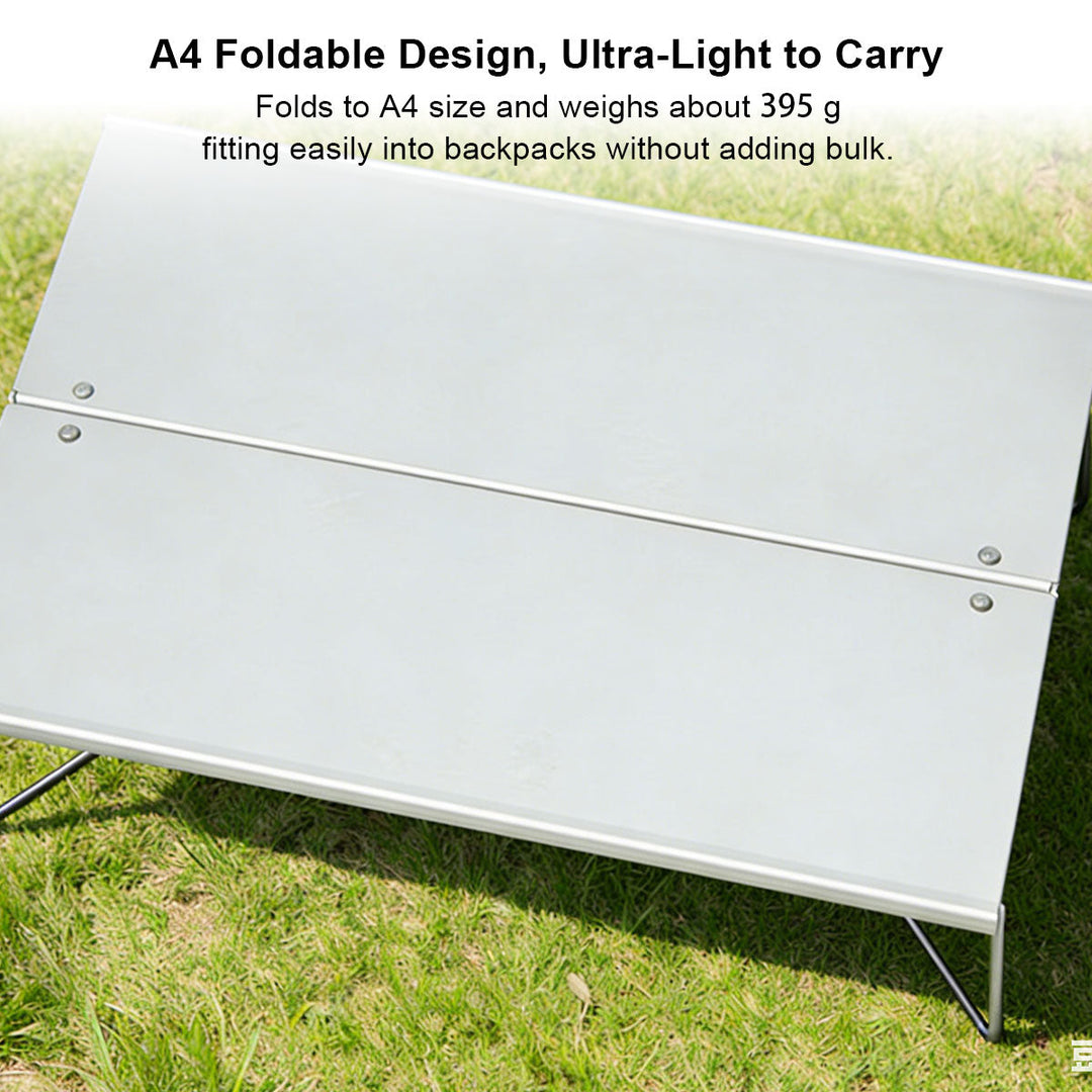 Foldable aluminum camping table in use, set up outdoors with camping chairs, perfect for camp accessories.