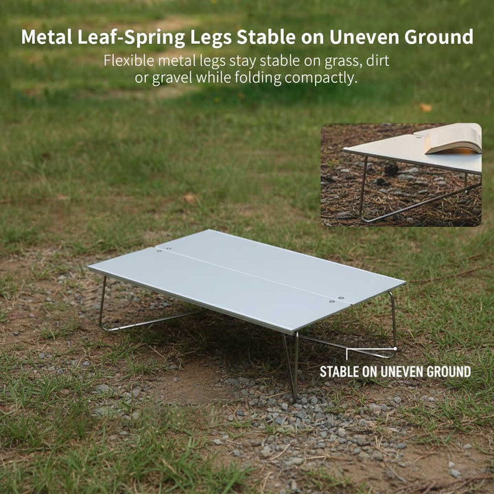 Portable aluminum camping table with A4 size, suitable for backpacking and hiking gear.