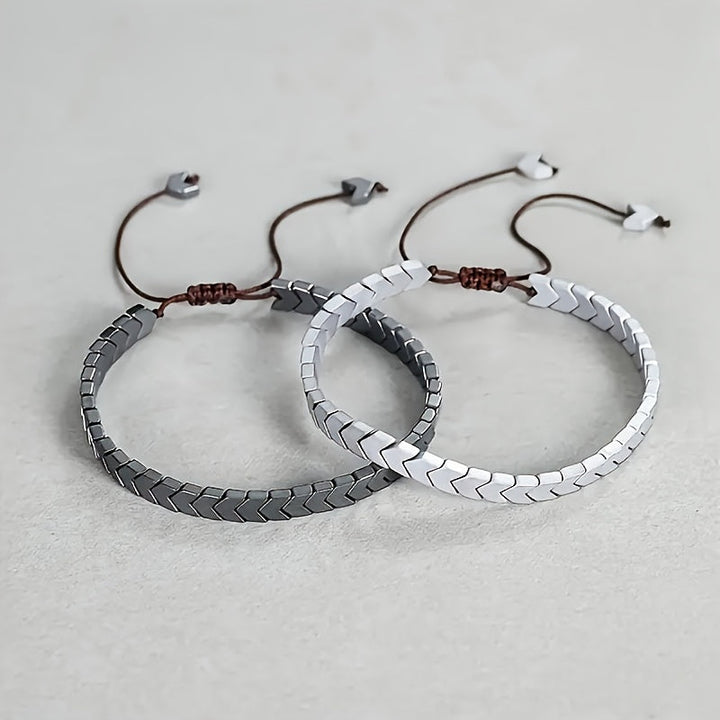 Unisex Arrowline Hematite gemstone bracelet. Adjustable beaded design in black, grey, and silver tones.