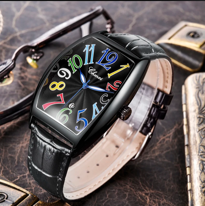 Leather strap dress watch in Art Deco style, featuring a sleek tonneau case and sunburst dial.